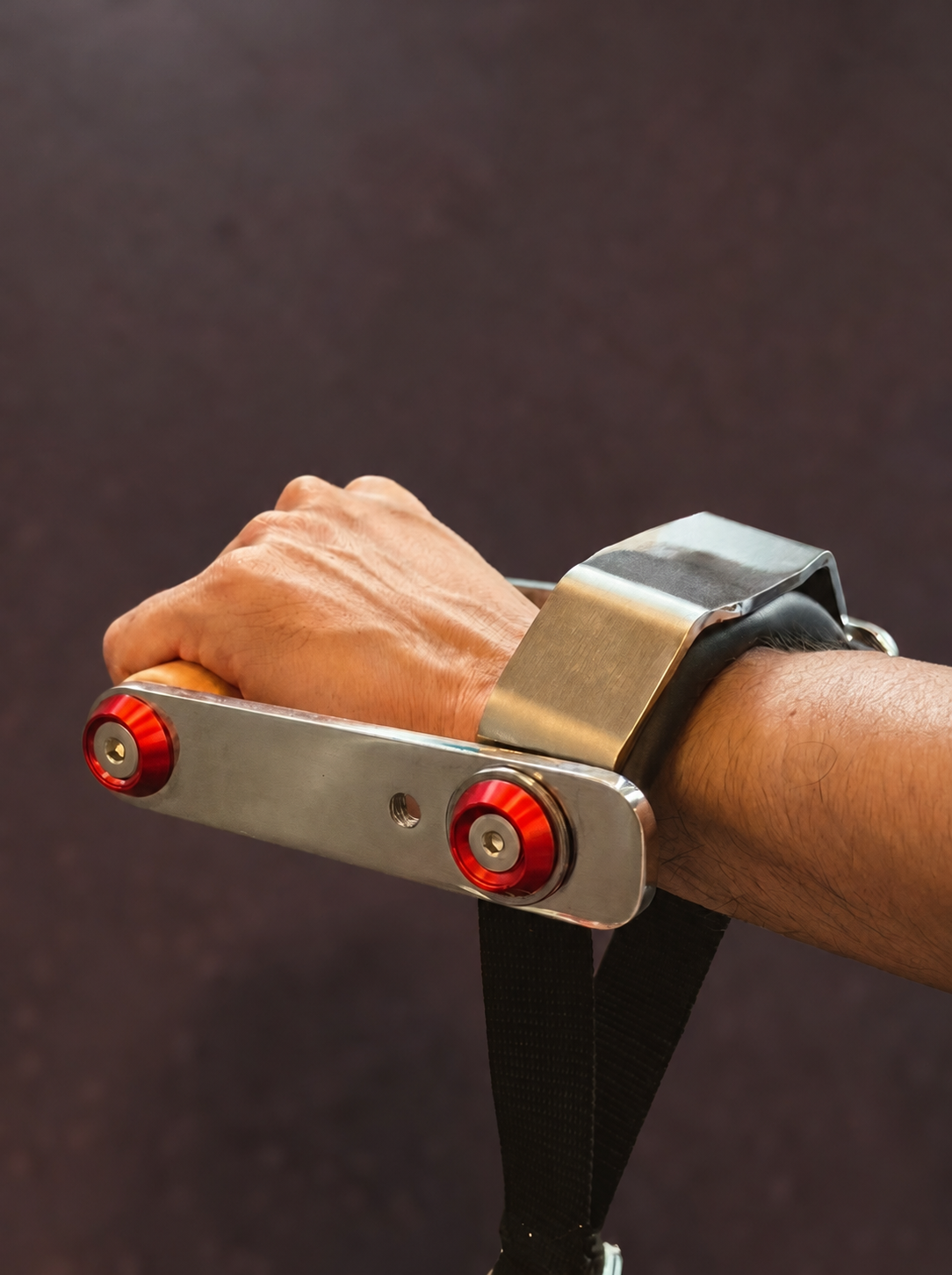 The padded cuff supporting a wrist during cable training